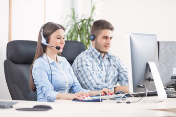 Portrait of two young people working in a call center