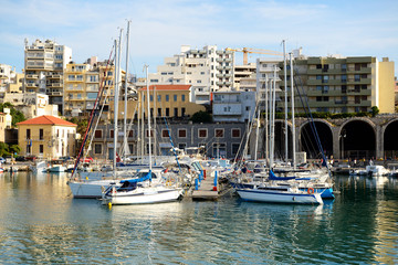 Fototapeta na wymiar The yachts and motor boats are near pier, Crete, Greece
