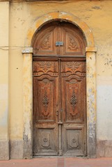 Ornate weathered wood door in Cuenca, Ecuador