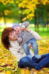 Fototapeta premium Young mother with her little baby having fun
