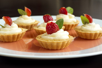 Tiny cupcakes with strawberry, whipped cream