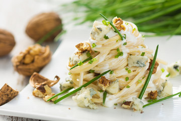 Pasta with gorgonzola on a wooden background