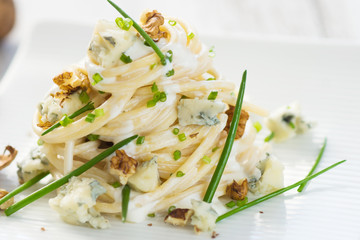Pasta with gorgonzola on a wooden background