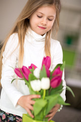 Little girl with bouquet of tulips