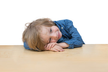 Adorable little boy on the table edge isolated over white 