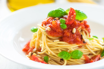 Spaghetti with tomato and basil leaves and chilli