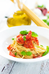 Spaghetti with tomato and basil leaves and chilli