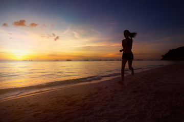 Fototapeta na wymiar Silhouette of fitness woman jogging at sunrise
