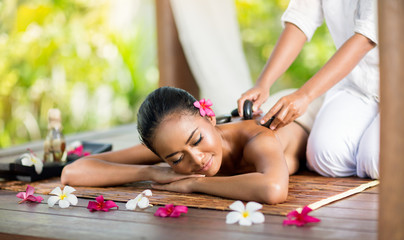 Young woman enjoying a hot stone massage