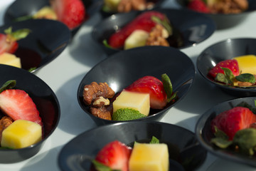 Starting party snack: cheese, strawberry, nut and mint