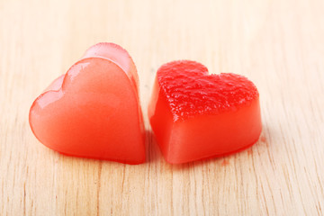 Obraz na płótnie Canvas two red heart-shaped ice from raspberry syrup