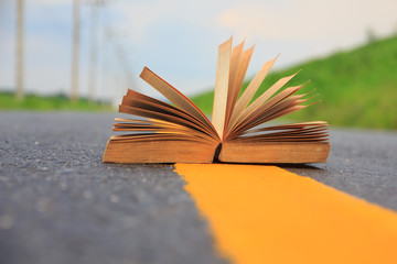 Stock Photo - Open book on road outdoors