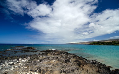 Fototapeta na wymiar Lava rocks and reefs at Mauna Kea Beach