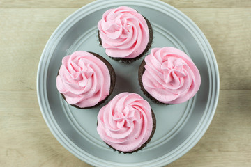 Obraz na płótnie Canvas Chocolate Cupcakes with pink icing