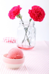 red homemade strawberry ice cream and red carnation flower