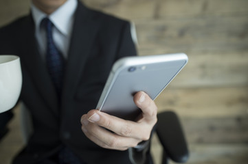 Businessmen are using the latest mobile phone