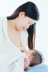 Beautiful asian mother breastfeeding her baby
