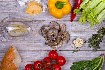 Delicious fresh shrimps and vegetables on wooden background