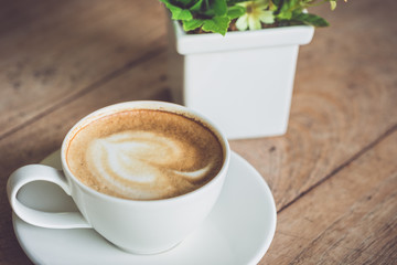 White coffee cup on the table at morning time