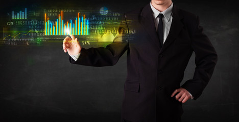 Young business person touching colorful charts and diagrams