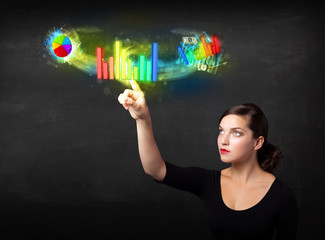 Young businesswoman touching colorful modern graph system concep