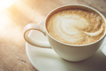 White coffee cup on the table at morning time