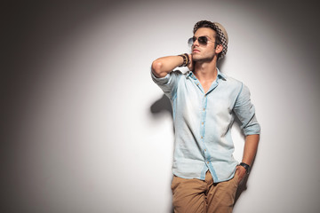 Fototapeta premium fashion man holding his hand to his neck