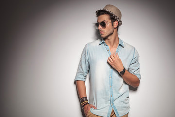 Handsome young casual man looking to his side