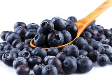 Fresh blueberries in wooden spoon