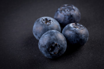Blueberries on stone plate background