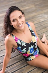 Pretty brunette sitting in swimwear 