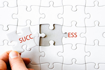 Fototapeta premium Missing jigsaw puzzle piece completing word SUCCESS