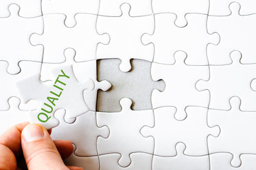 Fototapeta premium Missing jigsaw puzzle piece with word QUALITY