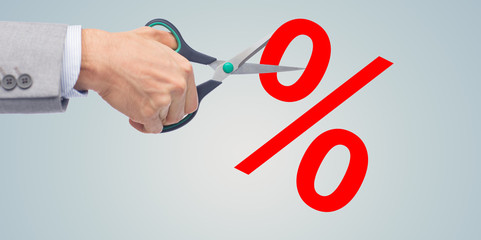 close up of businessman with scissors and percents