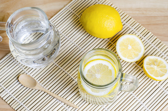 Soda with lemon in jar on wooden table