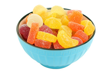 Colorful candies in glass bowl isolated on white