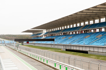 Naklejka premium empty speedway and bleachers on stadium