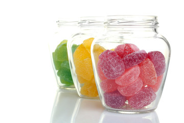 Colorful candies in glass bowl isolated on white