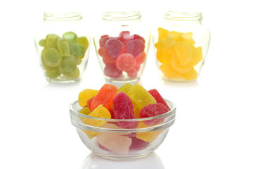 Colorful candies in glass bowl isolated on white