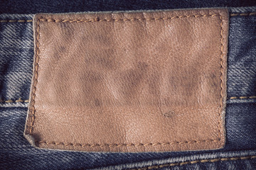 brown leather tag on blue jeans