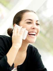 Delighted young woman listening to a phone call