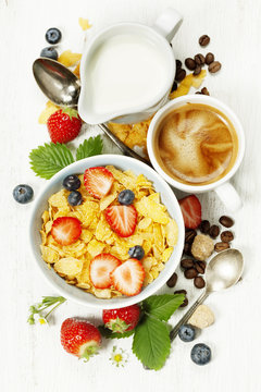 Breakfast with coffee, corn flakes, milk  and berry