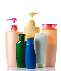  plastic bottles of body care and beauty products on white