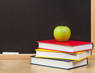 Back to school. School board and books and apple isolated
