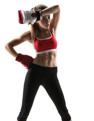 Fototapeta premium Tired brunette with boxing gloves having rest after workout