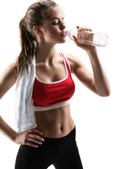 Sporty muscular woman drinking water