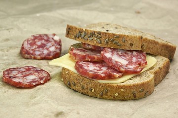 Sandwich With Dried Smoked Sausages Slices And Cheese
