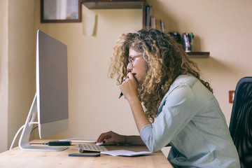 Young woman working at home or in a small office