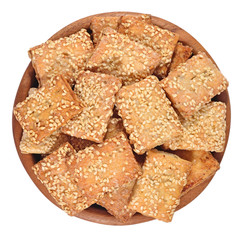 Cookies with sesame seeds in a wooden bowl on a white