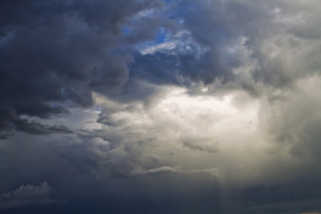 Sunlight is streaming through storm clouds